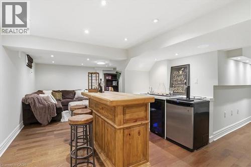 Custom built-in bar with wood-finish countertop, stainless steel appliances, and integrated sink - 19 Forestview Drive, Cambridge, ON - Indoor