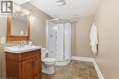 Bathroom featuring a wood vanity with integrated sink, chrome faucet, and overhead bar light fixture - 19 Forestview Drive, Cambridge, ON - Indoor Photo Showing Bathroom