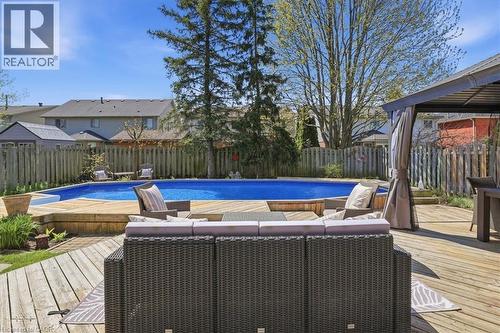 Expansive wooden deck surrounding an in-ground swimming pool - 19 Forestview Drive, Cambridge, ON - Outdoor With Above Ground Pool With Backyard