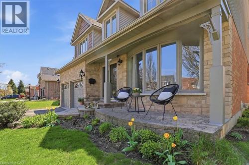 Stone veneer and brick exterior featuring a covered porch with decorative columns - 19 Forestview Drive, Cambridge, ON - Outdoor With Deck Patio Veranda
