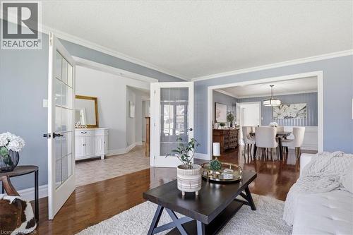 Hardwood-finish flooring extending into the dining area, featuring a decorative chandelier - 19 Forestview Drive, Cambridge, ON - Indoor Photo Showing Living Room