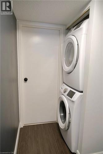 Dedicated laundry area featuring a stacked washer and dryer unit - 175 Hunter Street E Unit# 301, Hamilton, ON - Indoor Photo Showing Laundry Room