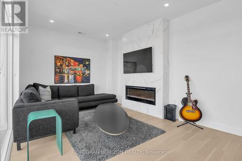 1105 - 71 Wyndham Street S, Guelph, ON - Indoor Photo Showing Living Room With Fireplace