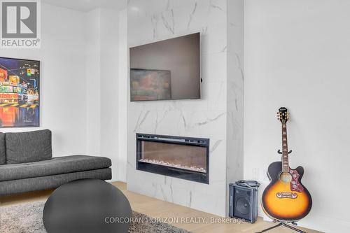 1105 - 71 Wyndham Street S, Guelph, ON - Indoor Photo Showing Living Room With Fireplace