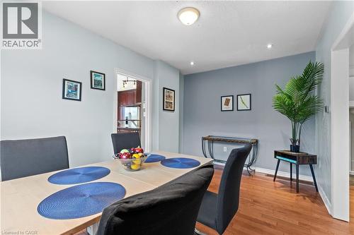 Dining area featuring wood-finish flooring, recessed lighting, a modern ceiling light fixture, and a doorway opening to an additional room - 204 Beach Boulevard, Hamilton, ON - Indoor Photo Showing Dining Room
