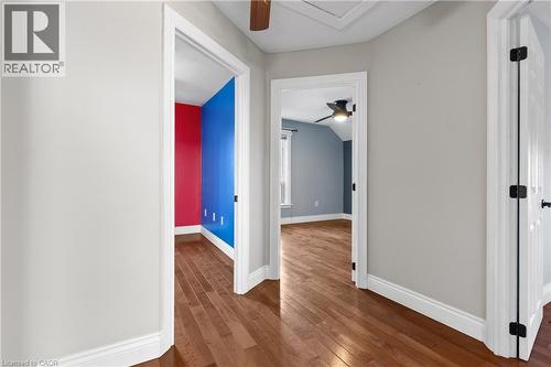 Hallway with wood-finish flooring, light gray wall paint, and white trim - 204 Beach Boulevard, Hamilton, ON - Indoor Photo Showing Other Room