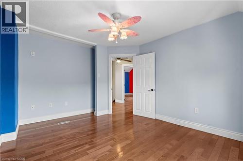 Interior room featuring wood-finish flooring, light blue walls, and a ceiling fan with integrated lighting - 204 Beach Boulevard, Hamilton, ON - Indoor Photo Showing Other Room