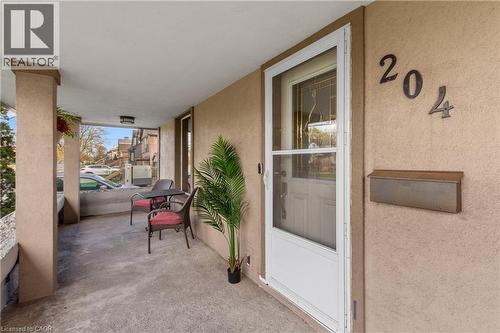 Covered front porch featuring stucco columns, a concrete surface, and a wall-mounted mailbox - 204 Beach Boulevard, Hamilton, ON - Outdoor With Exterior