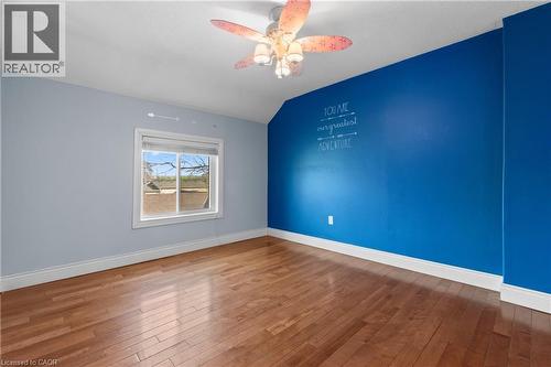Bedroom with wood-finish flooring, a ceiling fan with integrated lighting, and a single window with white trim - 204 Beach Boulevard, Hamilton, ON - Indoor Photo Showing Other Room