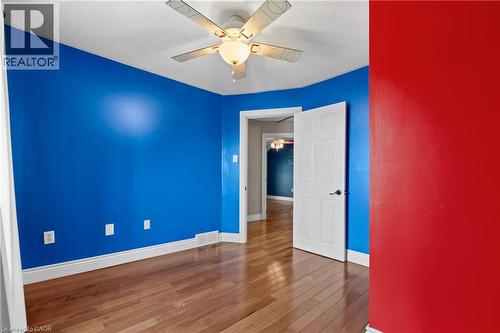 Room featuring wood-finish flooring, white baseboards, and a ceiling fan with light fixture - 204 Beach Boulevard, Hamilton, ON - Indoor Photo Showing Other Room