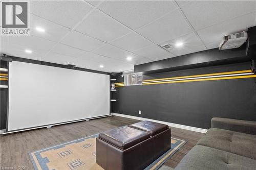 Entertainment room featuring a large projection screen, recessed lighting, and wood-finish flooring - 204 Beach Boulevard, Hamilton, ON - Indoor