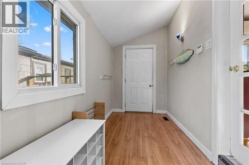 Mudroom entryway featuring wood-finish flooring, a white paneled door, and a large window with white trim - 204 Beach Boulevard, Hamilton, ON - Indoor Photo Showing Other Room