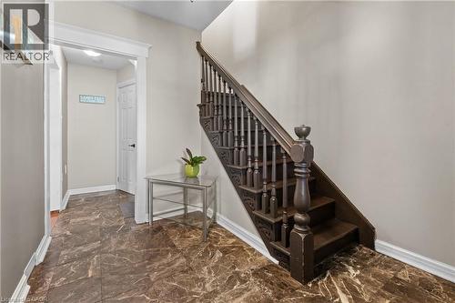 Staircase with dark wood newel post and balusters, featuring carved detailing - 204 Beach Boulevard, Hamilton, ON - Indoor Photo Showing Other Room