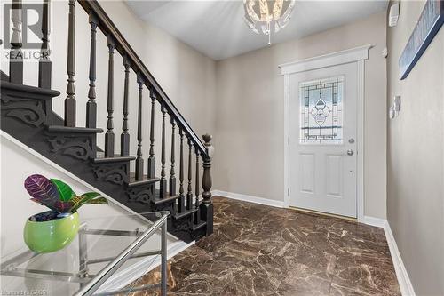 Entryway featuring a dark wood staircase with ornate carved details - 204 Beach Boulevard, Hamilton, ON - Indoor Photo Showing Other Room