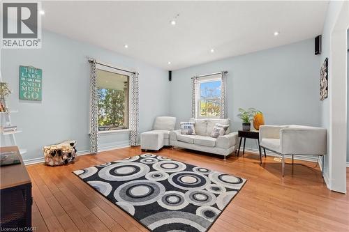 Spacious living area featuring polished wood-finish flooring, light blue wall tones, and recessed lighting - 204 Beach Boulevard, Hamilton, ON - Indoor Photo Showing Living Room