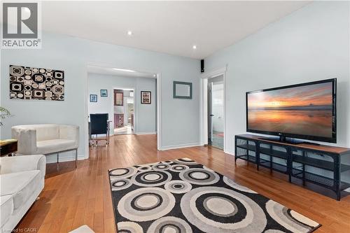 Hardwood-finish flooring throughout, featuring recessed lighting, light-toned wall paint, and an open doorway leading to an additional interior space - 204 Beach Boulevard, Hamilton, ON - Indoor Photo Showing Other Room