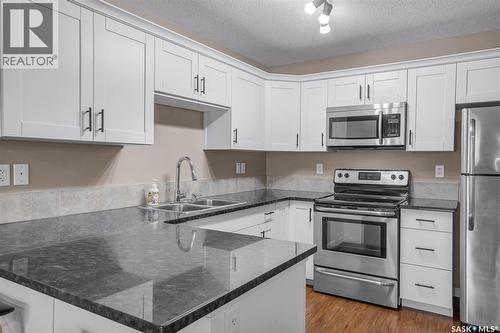 128 125 Willis Crescent, Saskatoon, SK - Indoor Photo Showing Kitchen With Stainless Steel Kitchen With Double Sink