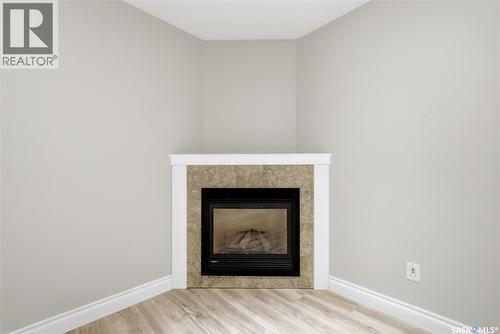 9382 Wascana Mews, Regina, SK - Indoor Photo Showing Other Room With Fireplace