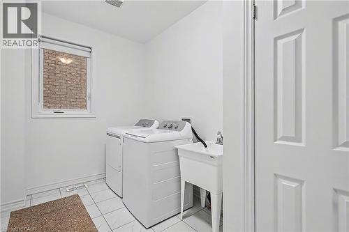 Dedicated laundry room featuring ceramic tile flooring, a utility sink, and a window with blinds - 123 Rea Drive, Fergus, ON - Indoor Photo Showing Laundry Room