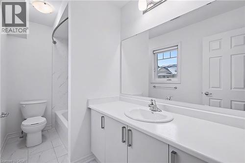 Bathroom featuring a vanity with an integrated sink, a large wall-mounted mirror, and a tub with a shower - 123 Rea Drive, Fergus, ON - Indoor Photo Showing Bathroom