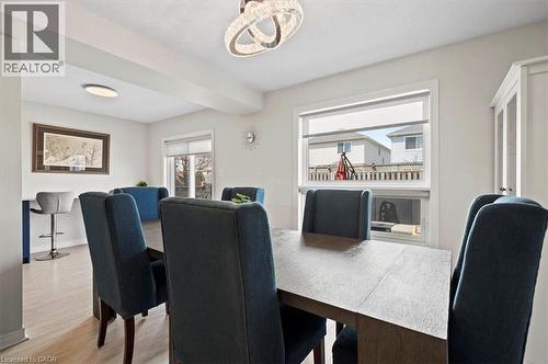 Dining area with light wood-finish flooring and a contemporary chandelier - 30 Heatherwood Place, Kitchener, ON - Indoor Photo Showing Dining Room