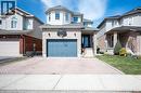 Two-story residence featuring light brick and light siding, an integrated single-car garage, and a bay window element - 30 Heatherwood Place, Kitchener, ON  - Outdoor With Facade 