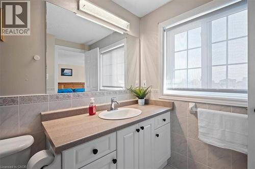 Bathroom vanity with white cabinetry and black knob hardware - 30 Heatherwood Place, Kitchener, ON - Indoor Photo Showing Bathroom
