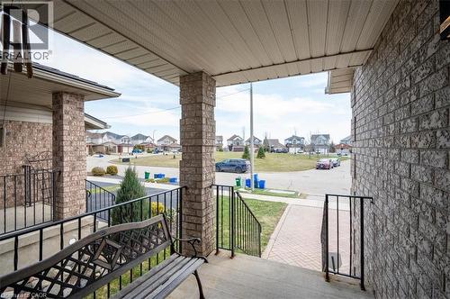 Inviting covered front porch with brick columns and black wrought iron railings - 30 Heatherwood Place, Kitchener, ON - Outdoor With Exterior