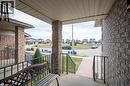 Inviting covered front porch with brick columns and black wrought iron railings - 30 Heatherwood Place, Kitchener, ON  - Outdoor With Exterior 