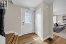 Entryway featuring wood-finish flooring, a white paneled entry door with decorative glass, and a built-in closet with bifold doors - 26 Peachtree Crescent, Cambridge, ON  - Indoor 