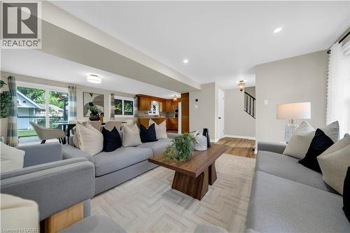 Open-concept living space featuring light-toned walls, recessed lighting, and herringbone-patterned area rug - 26 Peachtree Crescent, Cambridge, ON - Indoor Photo Showing Living Room