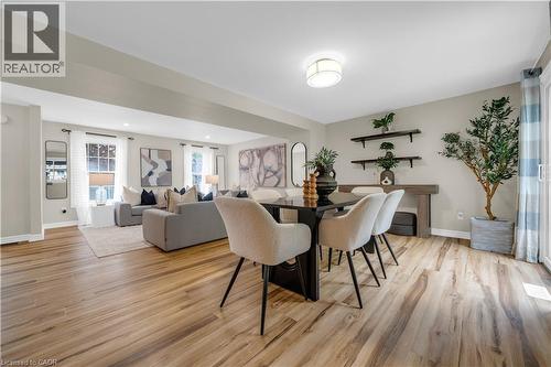 Spacious open-concept living and dining areas featuring wood-finish flooring, recessed lighting, and large windows - 26 Peachtree Crescent, Cambridge, ON - Indoor Photo Showing Other Room