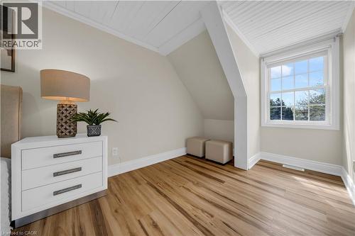 Room featuring wood-finish flooring, white ceiling paneling, and a double-hung window with a treed backdrop - 26 Peachtree Crescent, Cambridge, ON - Indoor Photo Showing Other Room