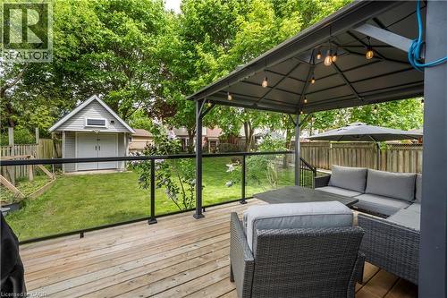 Wood-finish deck featuring a glass railing and a permanent gazebo with integrated string lighting - 26 Peachtree Crescent, Cambridge, ON - Outdoor With Deck Patio Veranda With Exterior