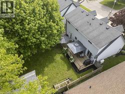 Expansive backyard featuring a manicured lawn, established landscaping, and mature trees - 