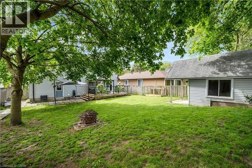 Expansive backyard with a generous lawn area and mature tree providing shade - 26 Peachtree Crescent, Cambridge, ON - Outdoor