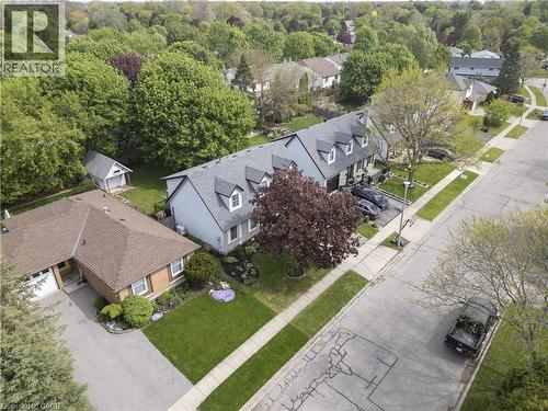 Townhome exterior featuring a light gray facade, multiple dormer windows, and a dark shingle roof - 26 Peachtree Crescent, Cambridge, ON - Outdoor With View