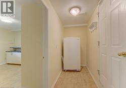 Functional area featuring light-toned walls, with door leading to garage - 