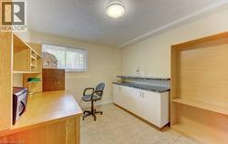 Room featuring light-toned flooring, a window providing natural light - 