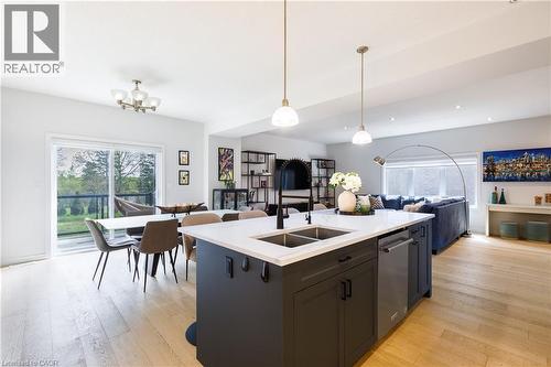 Open-concept living space featuring wood-finish flooring - 581 Doonwoods Crescent, Kitchener, ON - Indoor Photo Showing Kitchen With Double Sink