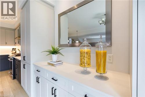 Built-in cabinetry featuring a white countertop and a contemporary mirror - 581 Doonwoods Crescent, Kitchener, ON - Indoor Photo Showing Kitchen