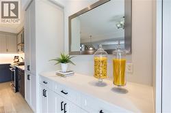 Built-in cabinetry featuring a white countertop and a contemporary mirror - 