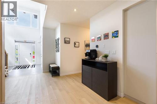 Two-story entryway featuring a white door with sidelights, transom window, and light wood-finish flooring - 581 Doonwoods Crescent, Kitchener, ON - Indoor Photo Showing Other Room