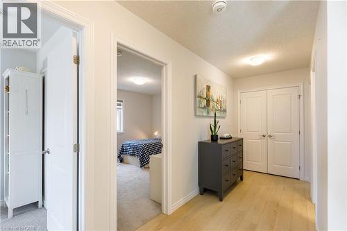 Interior hallway featuring wood-finish flooring, white trim, and light wall paint - 581 Doonwoods Crescent, Kitchener, ON - Indoor Photo Showing Other Room
