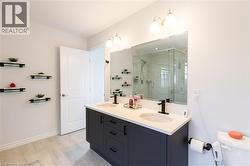 Double vanity with stone-finish countertop, undermount sinks, and matte black fixtures - 