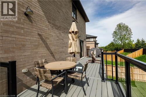 Exterior brick siding with a composite deck featuring glass panel railings - 581 Doonwoods Crescent, Kitchener, ON - Outdoor With Deck Patio Veranda With Exterior