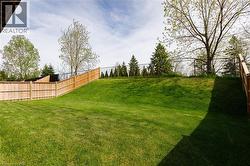 Expansive grassy yard with a gentle slope - 