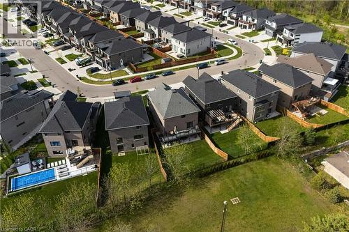 Residential neighborhood featuring contemporary homes with dark shingle roofs and fenced backyards - 581 Doonwoods Crescent, Kitchener, ON -  With View