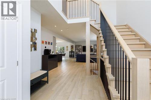 Grand entryway featuring a light wood-finish staircase with black metal balusters and matching upper-level railing - 581 Doonwoods Crescent, Kitchener, ON - Indoor Photo Showing Other Room