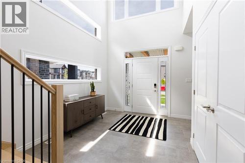 Bright entryway featuring a high ceiling, transom windows, and a panel-style front door with sidelights - 581 Doonwoods Crescent, Kitchener, ON - Indoor Photo Showing Other Room